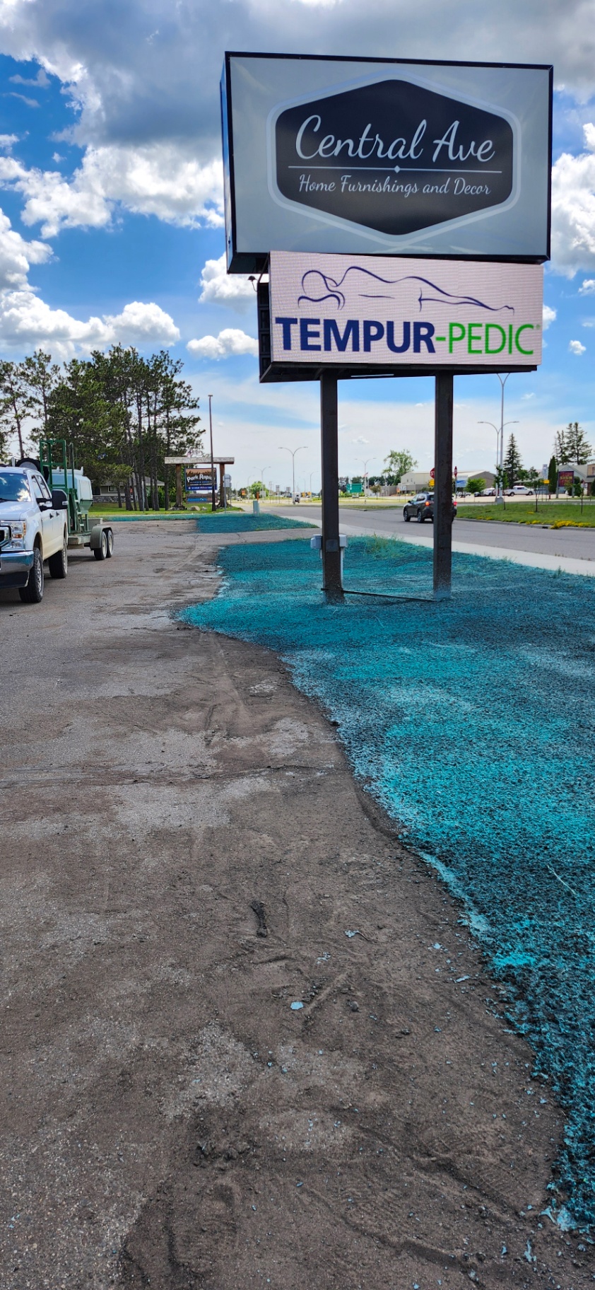 Hydroseeding around a commercial roadside sign