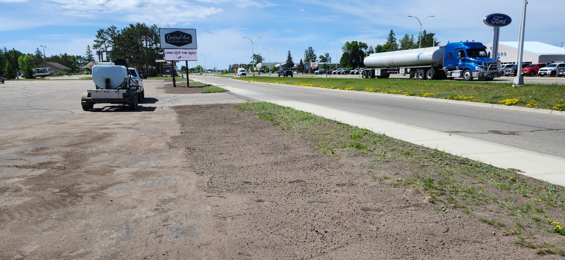 Service truck with hydroseed tank on commercial lot