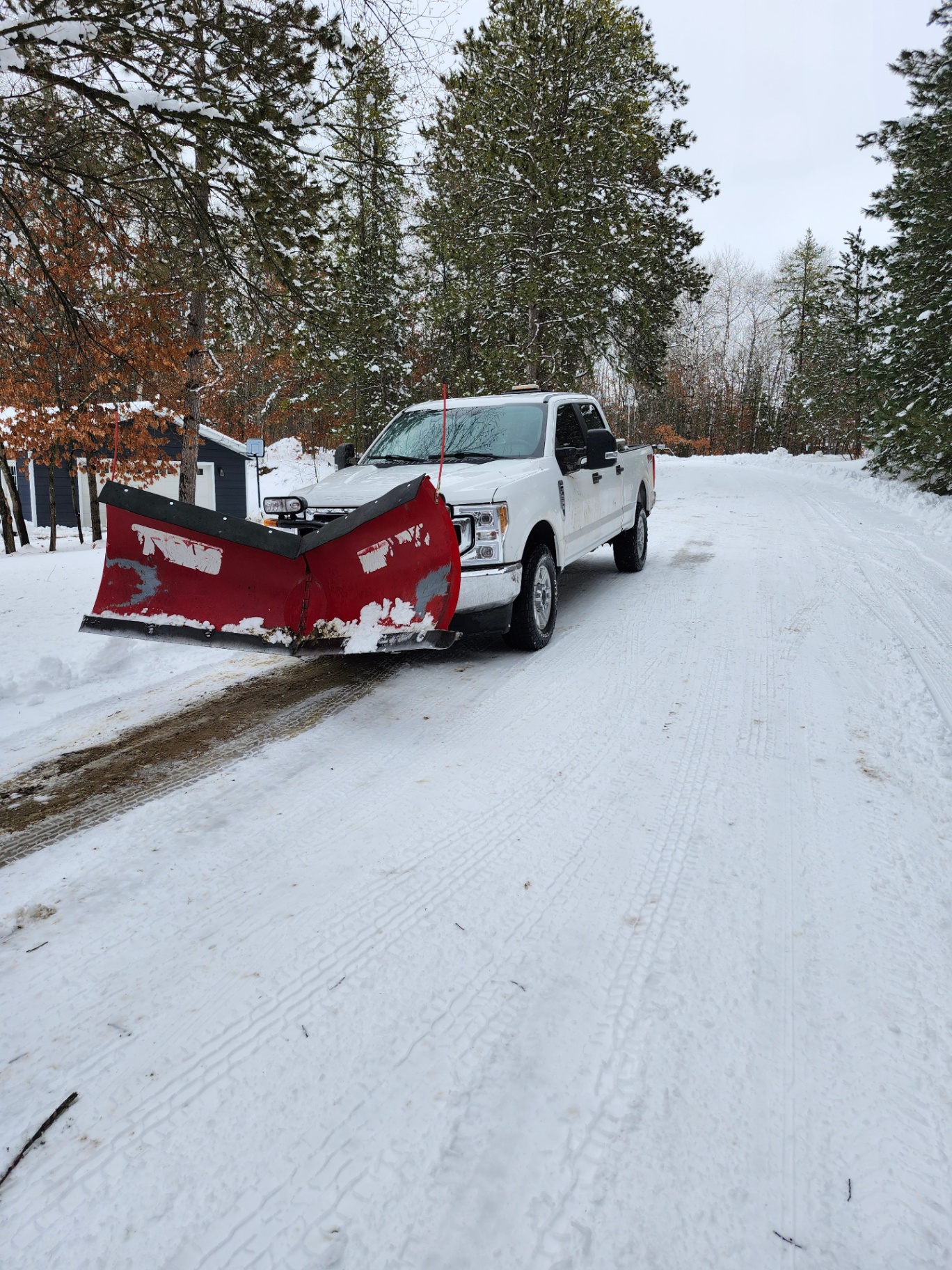 Plow truck on a cleared rural driveway